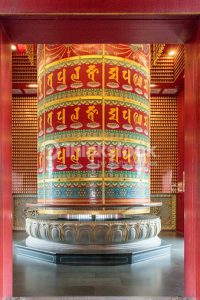 This large prayer wheel has the scripture imprinted on it so that when you turn it holding the railing, it is the same as reciting it. Found at the top of the Temple of the Tooth Relic in Singapore