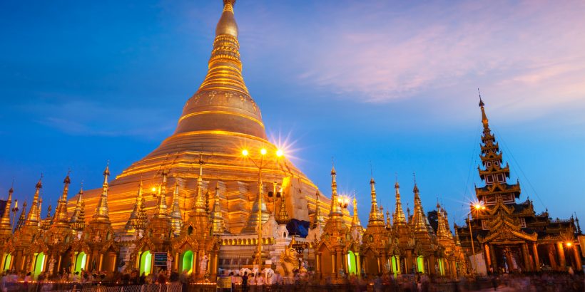 Myanmer famous sacred place and tourist attraction landmark - Shwedagon Paya pagoda illuminated in the evening. Yangon, Myanmar Burma