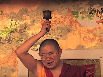 Buddha-Weekly-Garchen-Rinpoche-teaching-with-prayer-wheel-mani-wheel-mantra-Buddhism