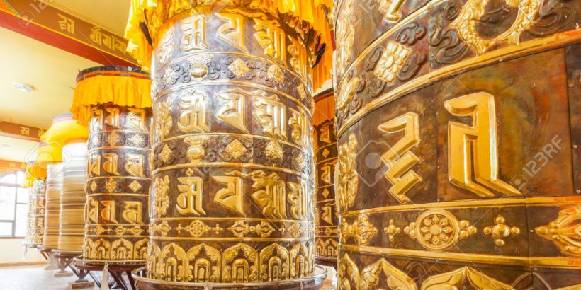 20562537-Buddhist-prayer-wheels-in-Tibetan-monastery-with-written-mantra-Yoksom-Sikkim-India--Stock-Photo