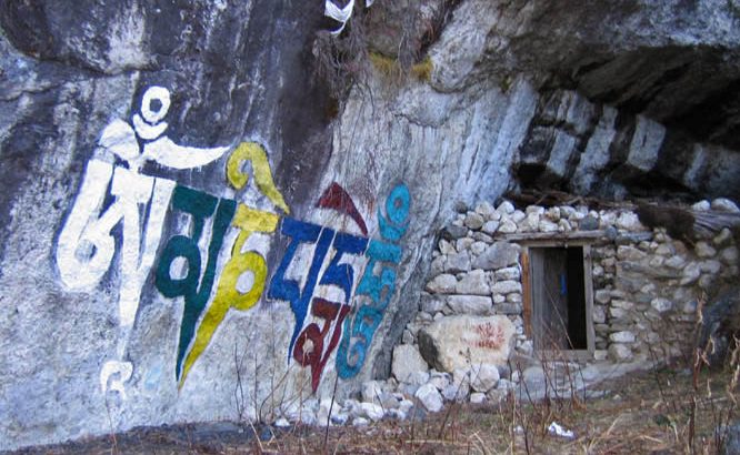A small retreat cave with Om Mani Padme Hum written on the rock in front. Lapchi, South Central Tibet.